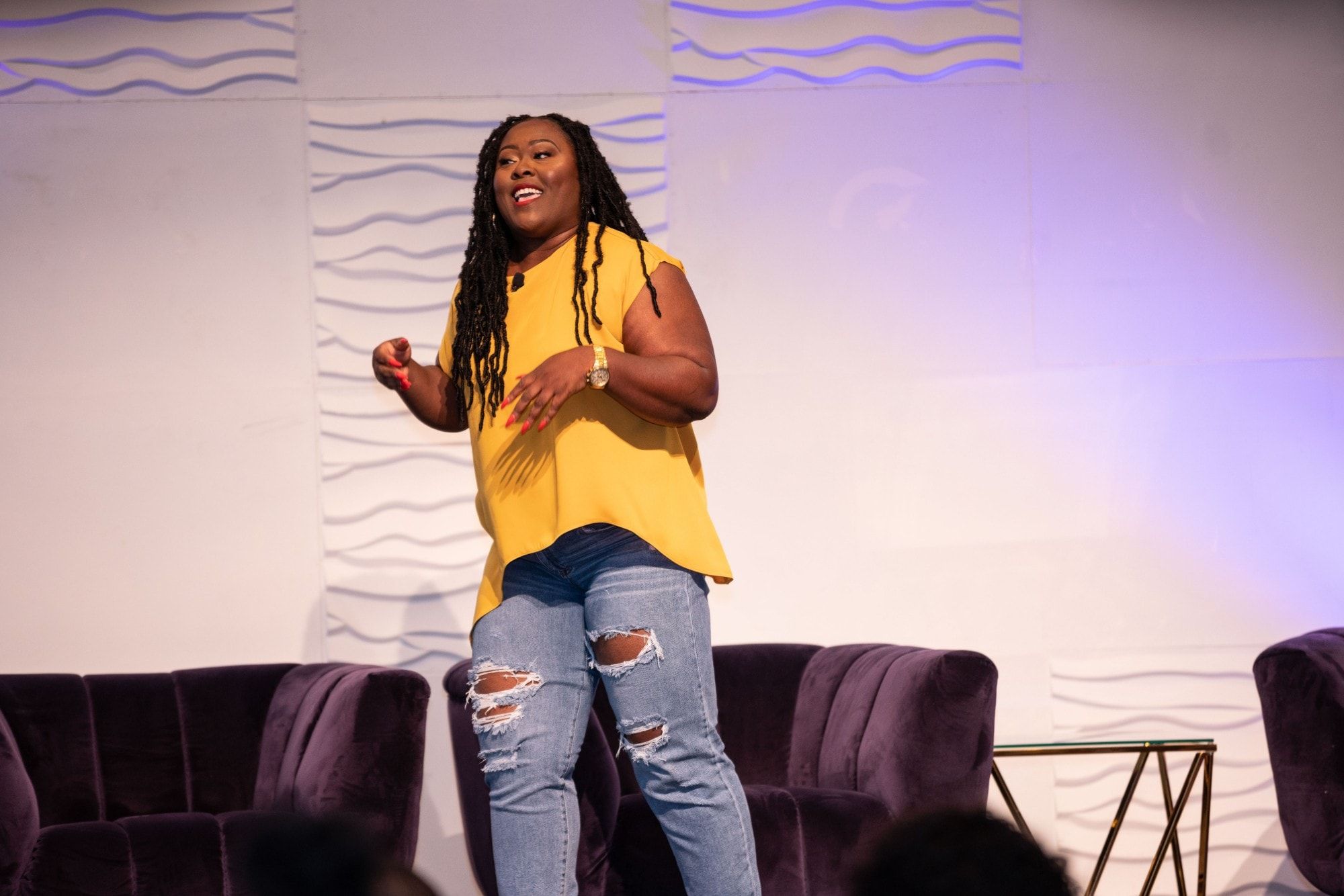 Ona on stage in a yellow top at Blk Pod Festival