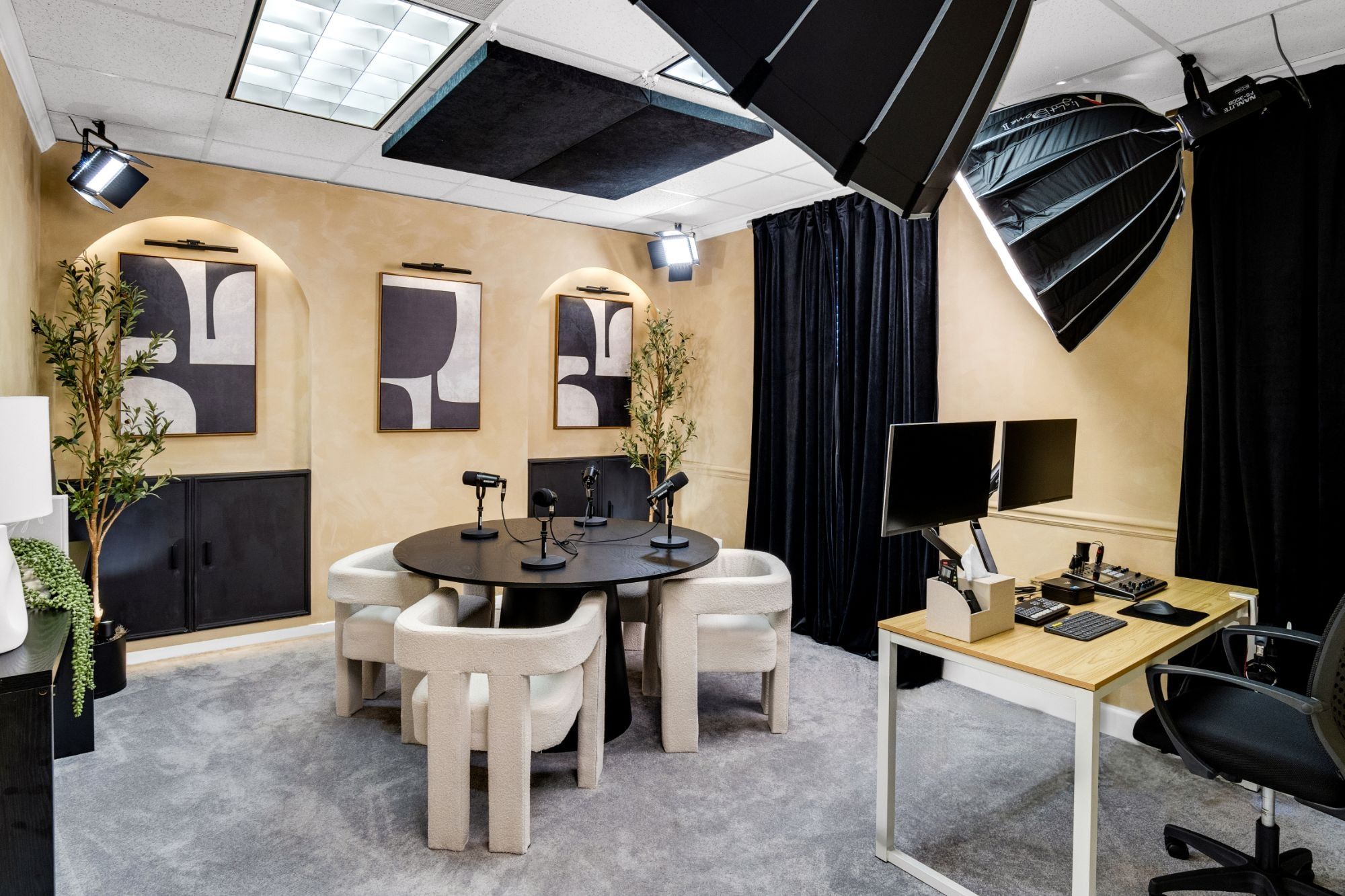 The Adode Studios podcast room with mics around a round table