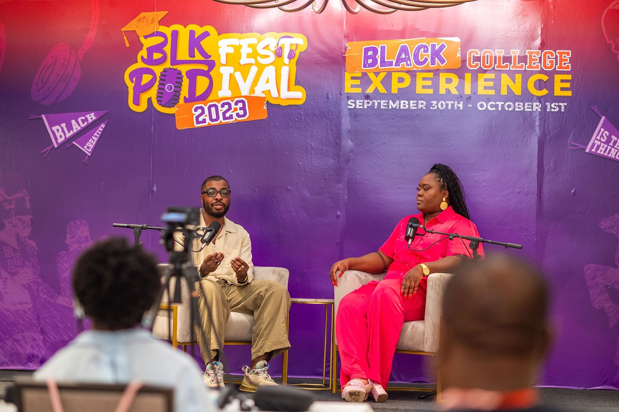 Ona in pink on a panel at Blk Pod Festival 2023